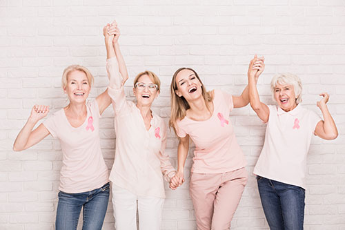 a group of women celebrating breast cancer survival